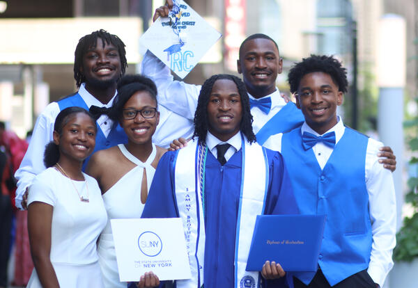 Class President James Campbell posing with his family and diploma
