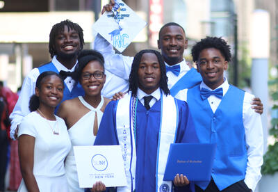 Class President James Campbell posing with his family and diploma