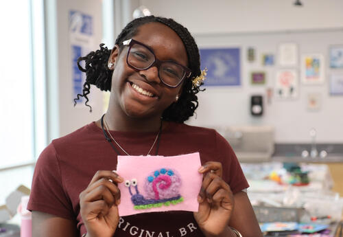 Student displaying artwork she created