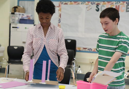 Students work on a STEM building project during summer programming.