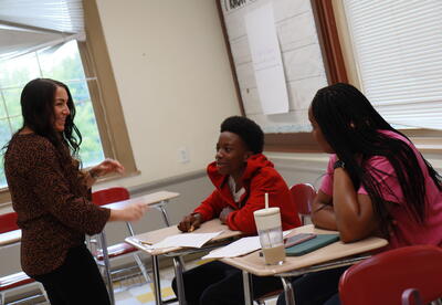 Students and a teacher laugh during summer school