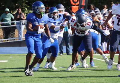 Photo of student holding football during a play