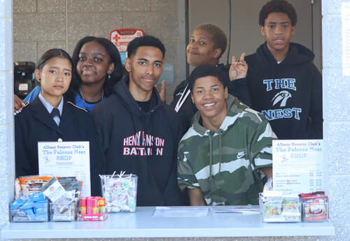 Photo of Albany Booster Club volunteers at the concession stand at a basketball game