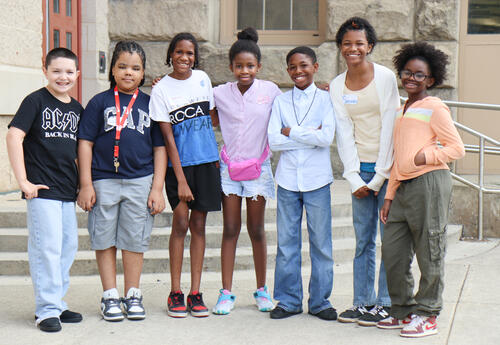 Group of students posing outside of William S. Hackett Middle School