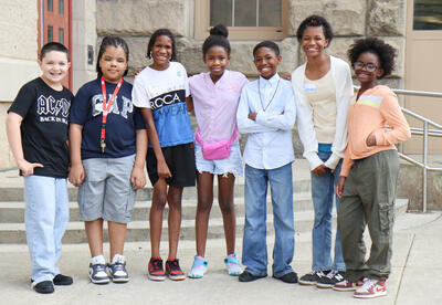 Group of students posing outside of William S. Hackett Middle School