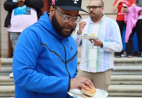 A Hackett employee participates in a staff BBQ.