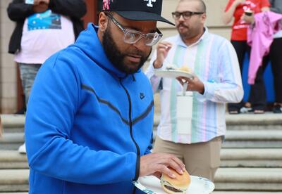A Hackett employee participates in a staff BBQ.