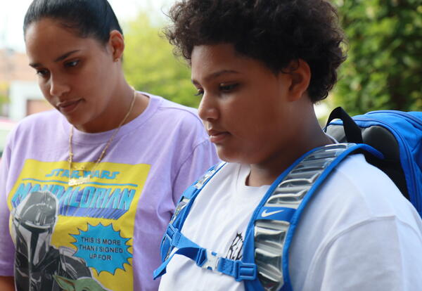A mother and student check in for the first day of school.