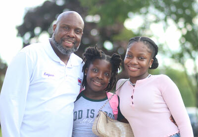 Family posing for a photo outside of Hackett