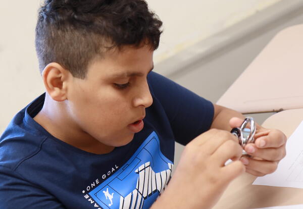 A student practices opening a combination lock.