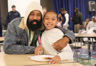 Pine Hills student posing with loved one at breakfast