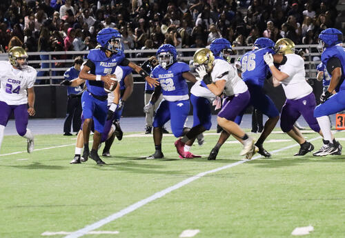 Photo of student holding the ball during a play