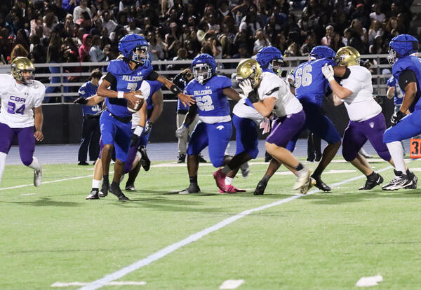 Photo of student holding the ball during a play