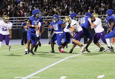 Photo of student holding the ball during a play