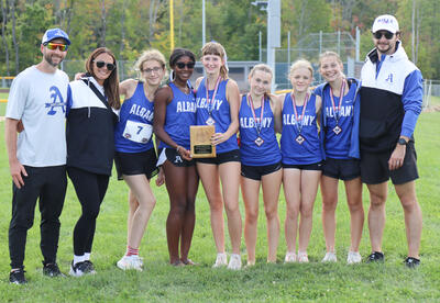 Girls' team and coaches holding second place plaque