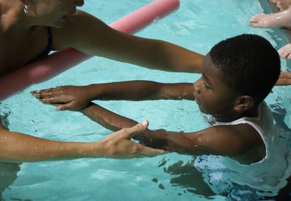 A student learns how to use his arms during a swim lesson at North 91��ɫ Middle School.