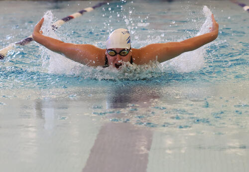 Student swimming the butterfly