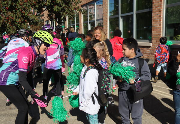 Bikers greet students on a ride to raise awareness for missing and exploited children.