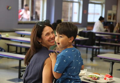 A mother and son eat bagels together.