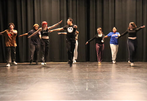 Ramirez working with students on stage
