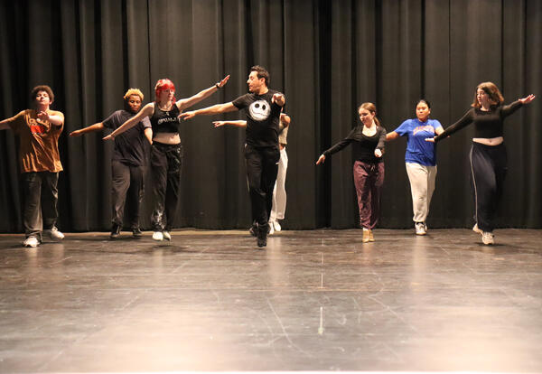 Ramirez working with students on stage