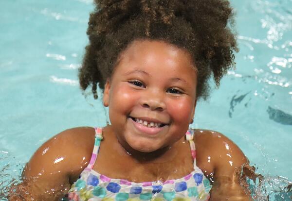 A second grade student participates in swim lessons.