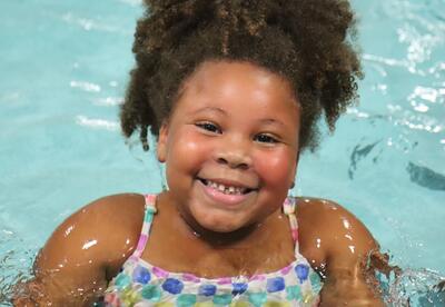 A second grade student participates in swim lessons.