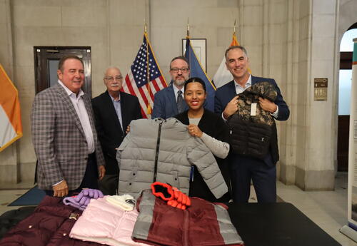 people holding coats