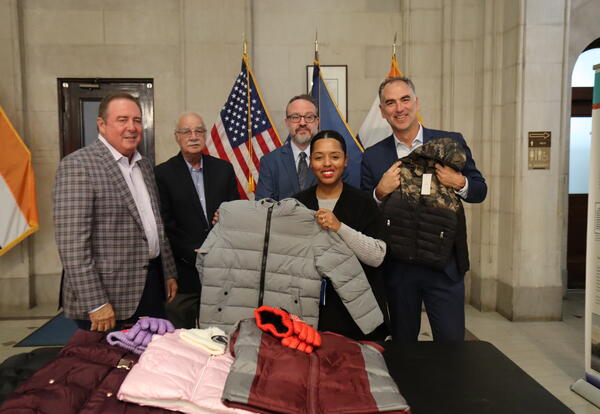 people holding coats