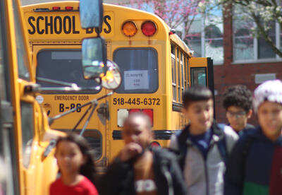 School bus parked in front a school at dismissal