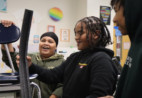 Students build roller coasters in science class.