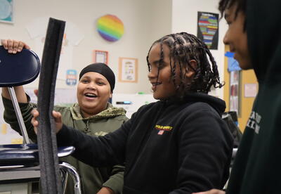 Students build roller coasters in science class.