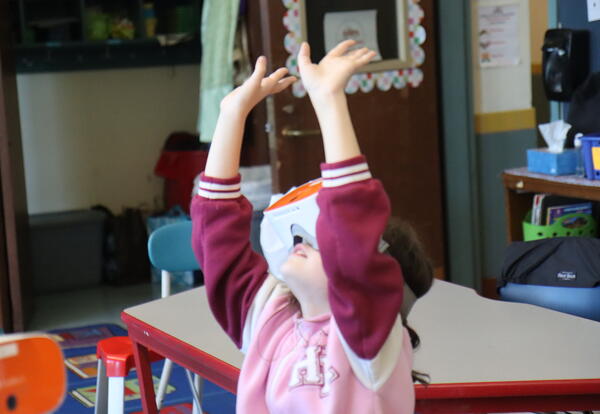 A students enjoys exlporing virtual reality with goggles.