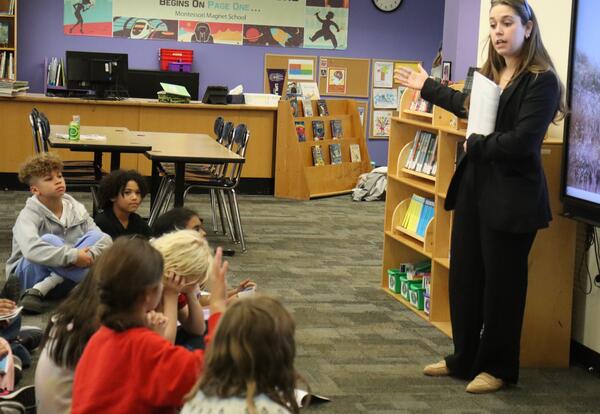 A representative from the district attorney's office speaks to grade 5 students.
