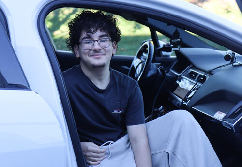 Student sitting in the WAYMO car