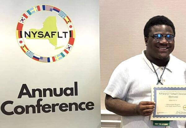 A teacher is given a world language award at a conference.