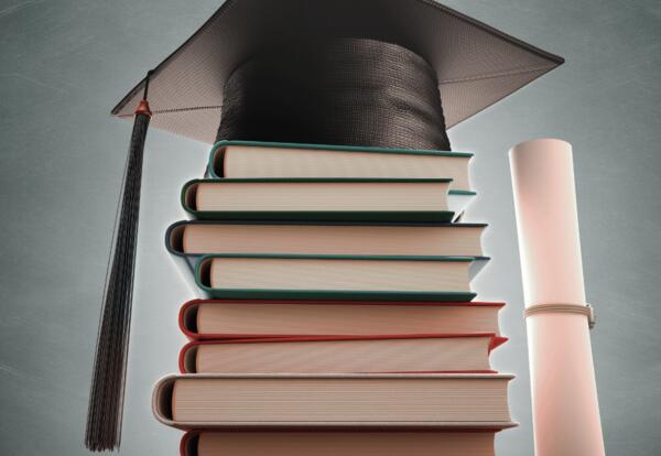 Photo of books and graduation cap with diploma