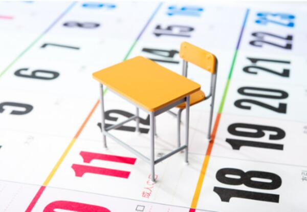 Calendar with a school desk and chair on top of it.