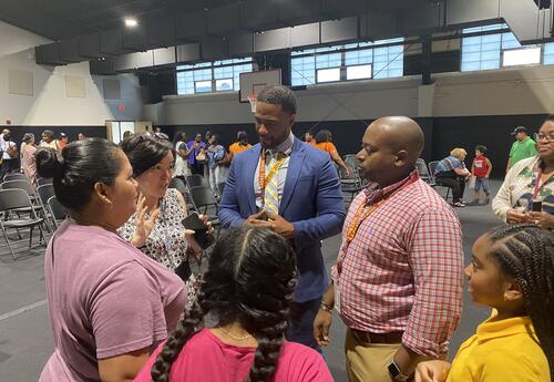 people standing in a group having a conversation