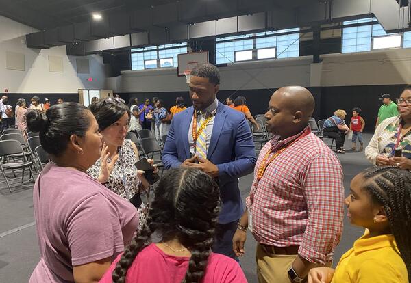 people standing in a group having a conversation