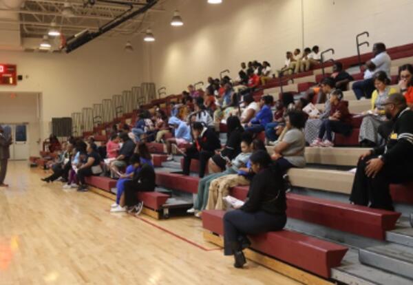 People Sitting in a gym at an event