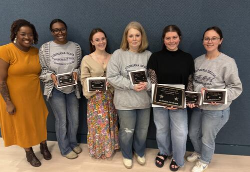Competition winners posing with program director.