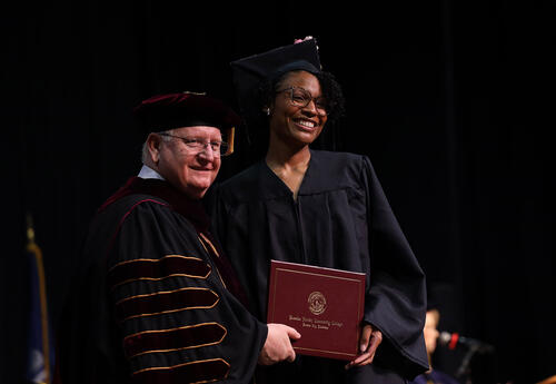 Graduate receiving diploma on stage