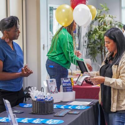 Student standing at a career job fair table. 