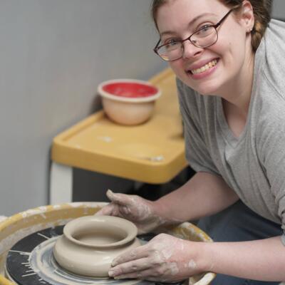 Enrichment student working on pottery wheel. 