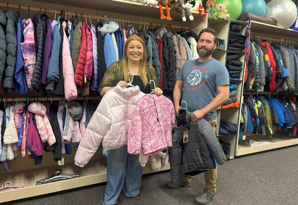School counselor Caitlin Livingston and custodian Chris Smiddy stand inside the new student “store” at Lee Elementary