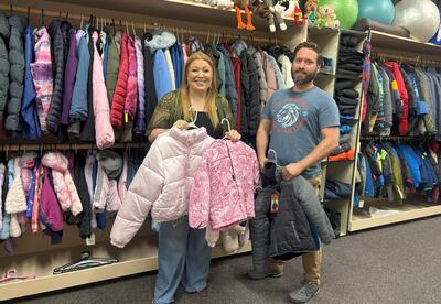 School counselor Caitlin Livingston and custodian Chris Smiddy stand inside the new student “store” at Lee Elementary