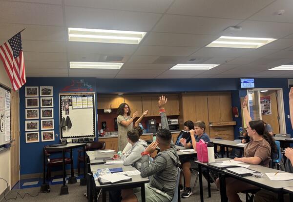 Megan Lavagnino leads a discussion with her 8th grade English students during a 9/11 unit, where students explore articles, video footage, and personal accounts to understand the impact of the attacks.