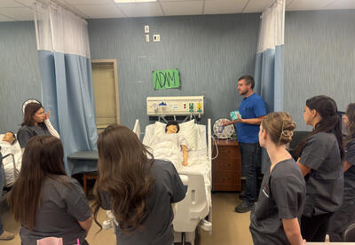 Eastmont alum and RN Nick Lolos guides students through their next clinical skill in Eastmont’s Foundations of Healthcare classroom.
