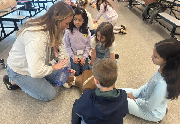 Eastmont nurses guided HiCap students through CPR practice, including chest compressions and bag-and-mask ventilation.